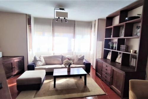 a living room with a couch and a coffee table at Apartamento en Navacerrada in Navacerrada