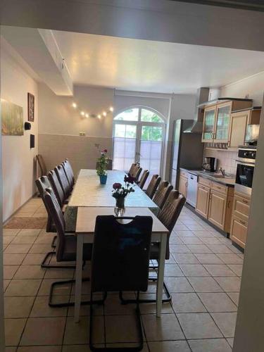 a kitchen with a dining room table and chairs at Seeblick zwei im Waldschlößchen in Wendisch Rietz