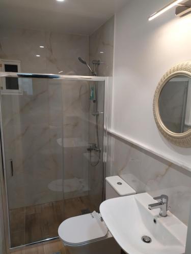 a bathroom with a shower and a toilet and a sink at Nafpaktos beach Apartment in Nafpaktos