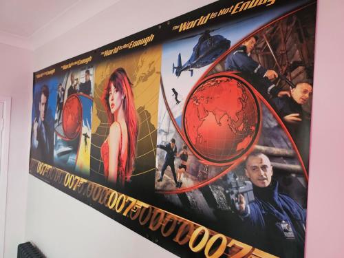 a poster for the movie spider man on a wall at Southsea Royale James Bond 3 bed Cool Penthouse, seafront parking in Portsmouth