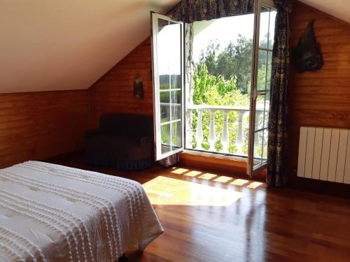 a bedroom with a bed and a large window at Finca La Sierra in Pillarno