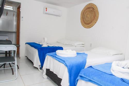 a room with two beds with blue sheets at Pousada Sereias de Maragogi in Ponta do Mangue