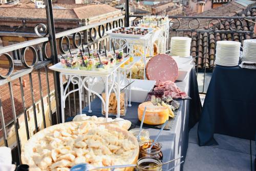 a buffet of food on a table on a balcony at Grand Hotel San Lorenzo in Mantova