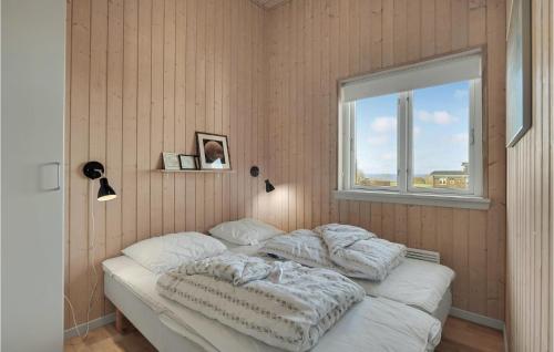 a bed in a room with a window at Amazing Home In Faaborg With Sauna in Fåborg