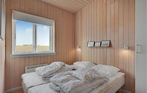 an unmade bed in a room with a window at Amazing Home In Faaborg With Sauna in Fåborg