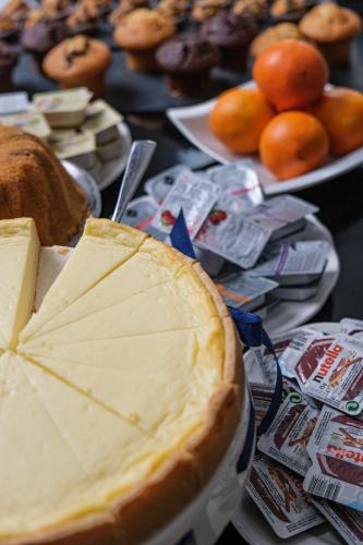 a table with a cheese pie and other foods at Hotel George Vienna in Vienna