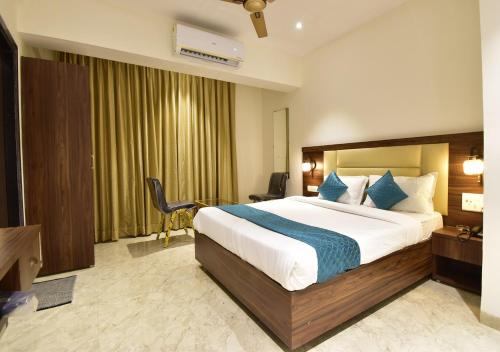 a bedroom with a large bed in a hotel room at Hotel Candor Amigo Airoli Mind Space in Navi Mumbai