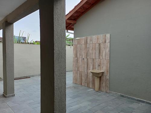 a room with a toilet on the side of a building at "Nossa Casa Da Praia" Peruíbe SP in Peruíbe