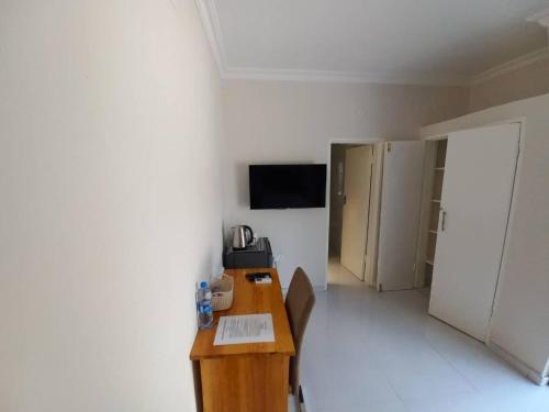 a room with a wooden desk in a room at Kasuda Rooms - Cosy self contained rooms in Livingstone
