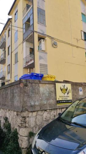 a car parked in front of a tall building at B&B Stadio in Catanzaro