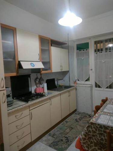 a kitchen with white cabinets and a counter top at B&B Stadio in Catanzaro