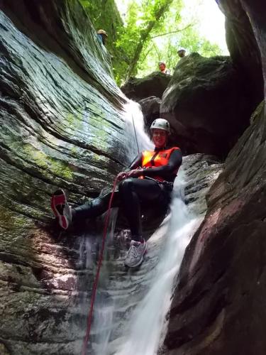 a man is sitting in front of a waterfall at La Locanda del Moro in Pieve Fosciana