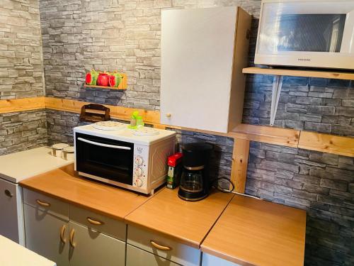 a microwave sitting on top of a kitchen counter at Camping house Relax with card for term 3000 in Moravske Toplice