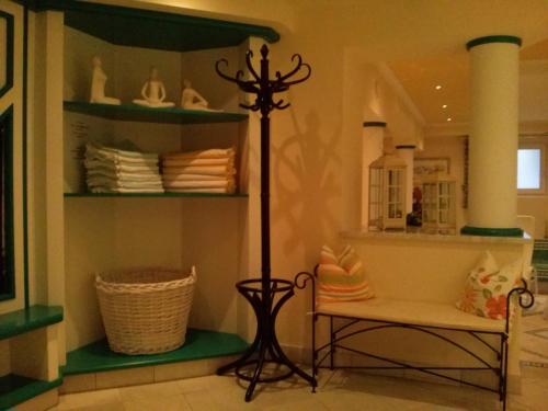 a room with a shelf with a lamp and a bench at Hotel Garni Erler in Mayrhofen