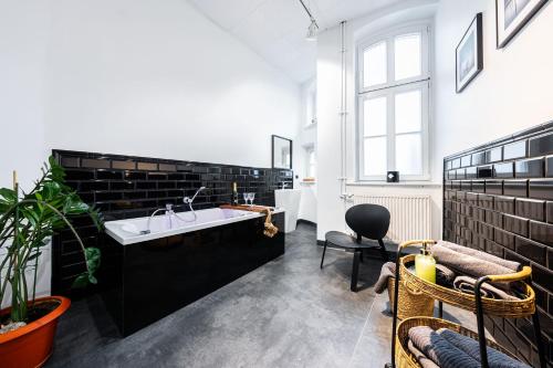 a bathroom with a large tub and a sink at LivingRoom 2 z wanną z hydromasażem in Katowice