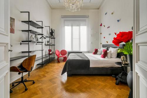 a bedroom with a bed and a chandelier at Museum Garden View Apartment Antwerp South in Antwerp