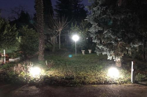 a park at night with lights in the grass at Casa Stella Malpensa in Cassano Magnago