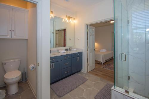 a bathroom with a toilet and a sink and a shower at 619 Porpoise Circle in St. Helena Island