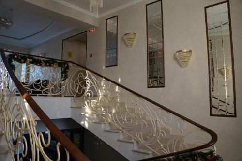a staircase with a wrought iron railing in a house at BeSt Hotel and Restaurant complex in Dunaivtsi