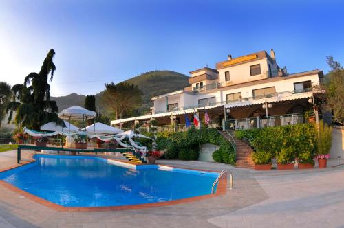 um hotel com piscina em frente a um edifício em Hotel Diecimare em Cava deʼ Tirreni