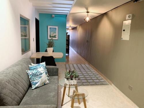 a living room with a couch and a table at Hotel Bisou in Cali