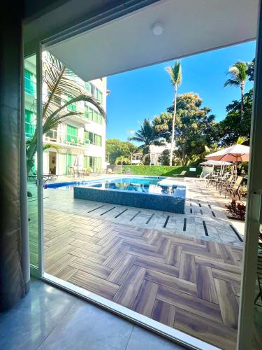 a sliding glass door with a view of a swimming pool at Gran Palma Residencial in Acapulco