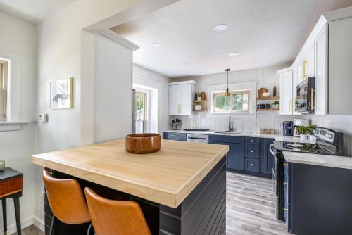 a kitchen with blue cabinets and a wooden counter top at The Akron Retreat: Modern 3-Bedroom Oasis in Akron