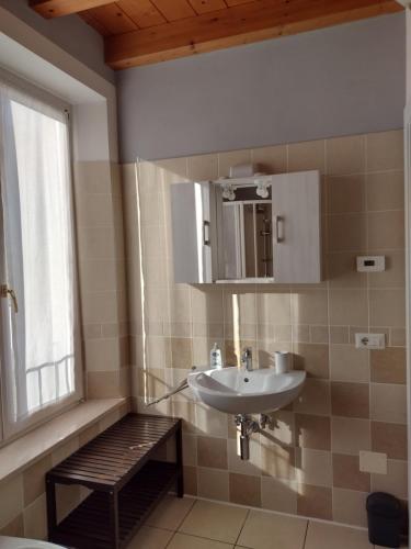 a bathroom with a sink and a window at Casa Terrazzo Panoramico in Cannobio