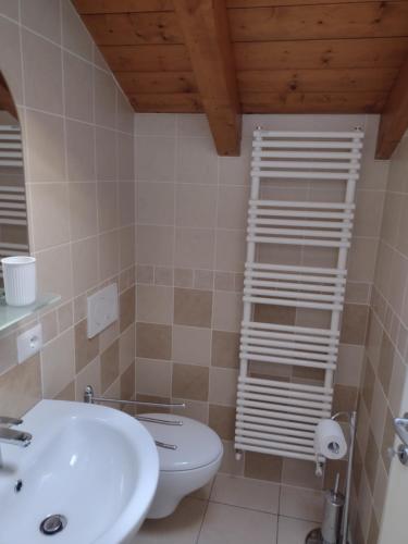 a bathroom with a white sink and a toilet at Casa Terrazzo Panoramico in Cannobio