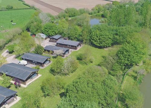 an overhead view of a group of buildings with trees at Goodiford Mill Lakes in Kentisbeare