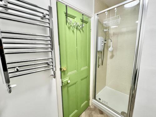 a green door in a bathroom with a shower at St Nicholas Street in Lincoln