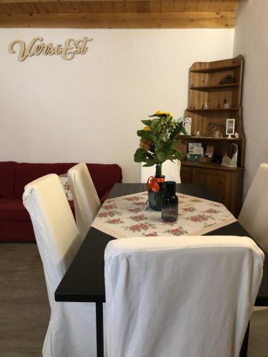 a table with a white table cloth and flowers on it at Verso Est in Petralia Soprana