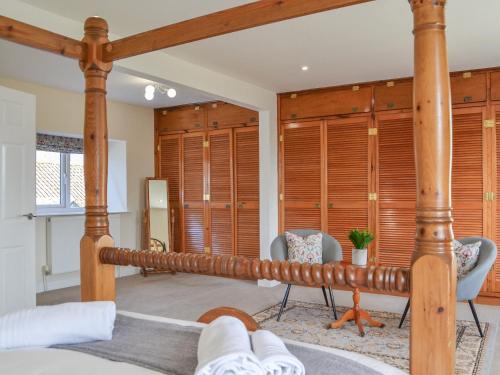 um quarto com uma cama e paredes de madeira em Springdale Farmhouse em North Burton