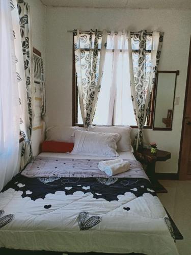 a bed in a room with a window at JCAH BEACH HOUSE free WiFi in Araceli