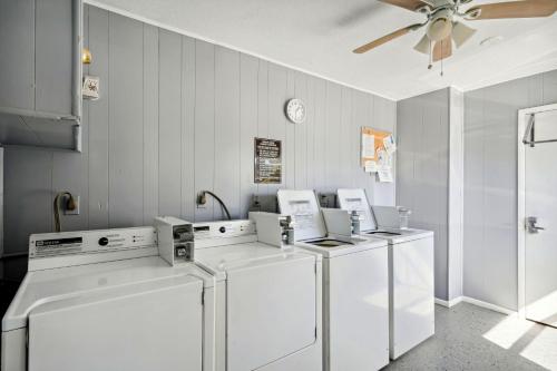 Zimmer mit 4 Waschmaschinen und einem Deckenventilator in der Unterkunft Harbor House 37 in St Pete Beach
