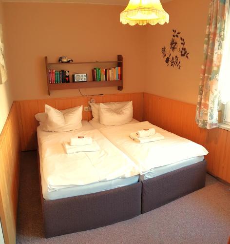 a bed in a room with two towels on it at Villa Helvetia in Bad Elster