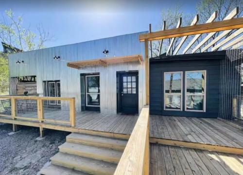 a home with a wooden deck with a black door at Downtown Views, Rooftop Deck, Pets in Dallas