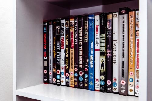 a row of dvds sitting on a shelf at Willow Chalet near Cartmel & Lake Windermere in Flookburgh