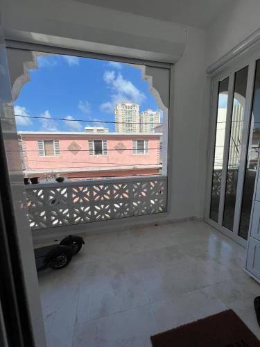 a room with a window with a view of a building at JOY in San Juan