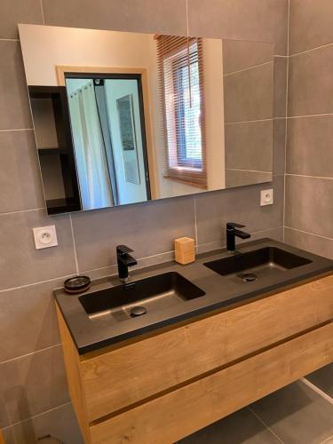 une salle de bain avec un lavabo et un miroir dans l'établissement Villa Griseor, à Porto-Vecchio