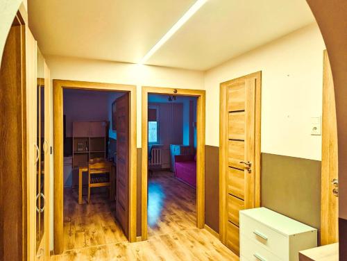 a room with a door and a room with a table at Apartment for a short rent in KaunasButas trumpalaikei nuomai Kaune in Kaunas