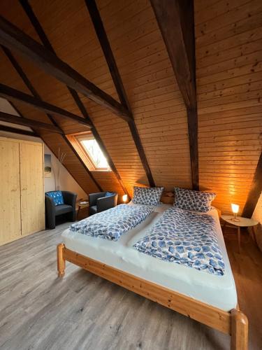 a bedroom with a large bed in a attic at Haus Friesenjungs in Böhl