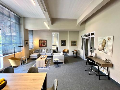 a living room with a couch and a table at No load-shedding Spacious Apartment in Cape Town