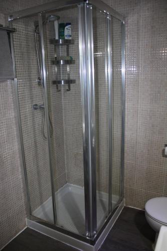 a shower stall in a bathroom with a toilet at HotSpot Valencia in Valencia