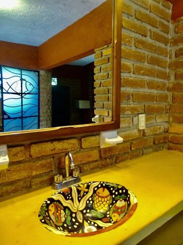 a bathroom with a sink with a stained glass window at Villas Vista Suites Sayulita in Sayulita