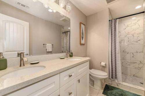 a bathroom with a sink and a toilet and a shower at Sacramento Two-Story Condo Near Oak Park Brewing! in Sacramento