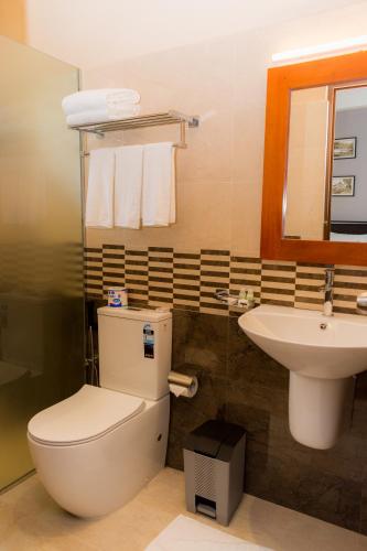a bathroom with a toilet and a sink at Kandy City View in Kandy