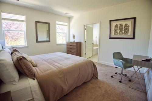 a bedroom with a bed and a desk and a chair at NEW Upscale House, Tahoe 30-min w/ Cal King in Steamboat