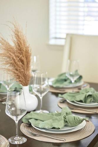 a table with plates and wine glasses on it at NEW Upscale House, Tahoe 30-min w/ Cal King in Steamboat
