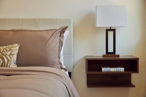 a bed with a lamp on a night stand next to a bed at NEW Upscale House, Tahoe 30-min w/ Cal King in Steamboat